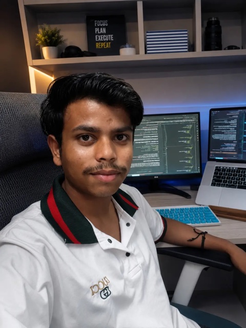 Vansh Kashyap at his development setup in New Delhi, with code open on dual monitors